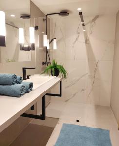 a bathroom with a sink and a shower at Design Apartment Vienna City Center - free parking! in Vienna