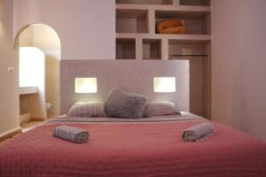 a bedroom with a bed with two remotes on it at Villa Sarah - Piscine chauffée in Sidi Kaouki