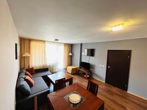 a living room with a couch and a table at Bansko Royal Towers Private Apartment V&K in Bansko