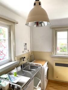 uma cozinha com um lavatório e uma máquina de lavar roupa em 1 - 2 Zimmer in historischem Altstadthaus em Freudenstadt
