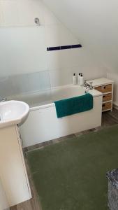 a bathroom with a white tub and a sink at Bexhill Sea View Flat 3 in Bexhill