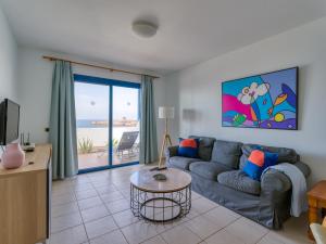 a living room with a couch and a table at Las Moreras Playa Blanca in Playa Blanca