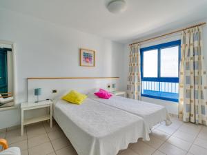 a bedroom with a bed with two pillows on it at Las Moreras Playa Blanca in Playa Blanca +170 photos