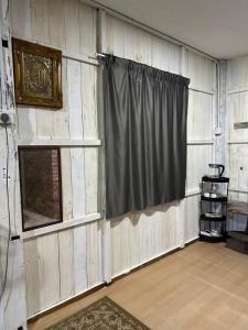 a room with a curtain and a window at Haji Othman Farm in Kuala Terengganu