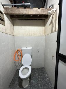 a small bathroom with a toilet in a stall at Haji Othman Farm in Kuala Terengganu