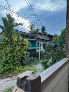 a house with a fence in front of it at Haji Othman Farm in Kuala Terengganu