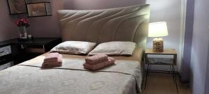 a bedroom with a bed with two towels on it at Apartman Gaga in Pirot