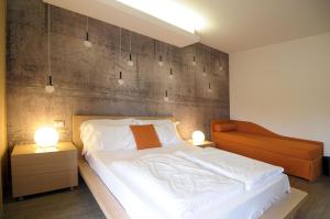 a bedroom with a large white bed and two lamps at Eco Hotel Cleofe in Caorle