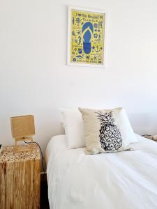 a bedroom with a bed and a picture on the wall at Henties Bay Haven Holiday Home in Hentiesbaai