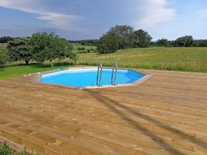 a swimming pool on top of a wooden floor at Apartament rural Can Ramon in Estanyol