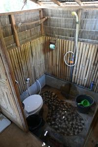 a small bathroom with a toilet and a shower at Bunga Jabe in Karimunjawa
