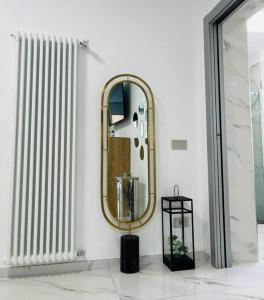 a bathroom with a mirror and a radiator at Casa El Trigal in Colico