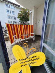 einen Balkon mit Stühlen, einem Tisch und einem Fenster in der Unterkunft Ferienwohnung FeWo Rottweil -kleine Auszeit- in Rottweil