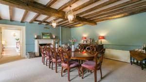 comedor con mesa de madera y sillas en Ty Fry Manor, en Pentraeth
