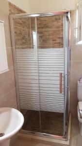a shower with a glass door in a bathroom at Kabos house in Mastorátika