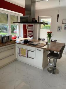 a kitchen with a wooden counter top and a table at traumhaft edle Landhauswohnung in Rosengarten