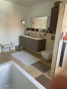 a bathroom with a tub and a sink and a toilet at traumhaft edle Landhauswohnung in Rosengarten +33 photos