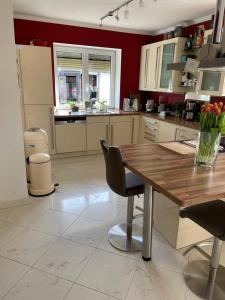 a kitchen with a wooden table and some chairs at traumhaft edle Landhauswohnung in Rosengarten