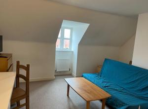a bedroom with a blue bed and a table at No-323 Signals Drive in Coventry
