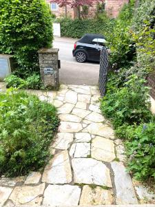 a stone walkway with a car parked in a driveway at 1 - 2 Zimmer in historischem Altstadthaus in Freudenstadt