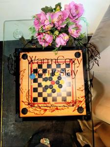 um tabuleiro de xadrez com flores em cima de uma mesa de vidro em Homestay Retail House Tol Exit Plus Bukit Beruntung em Kampung Sungia Buaya