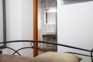 a bedroom with a bed with a mirror and a sink at Residence El Diez in Naples