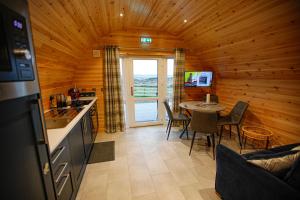 a kitchen and dining room of a log cabin at Berstane Lodges in Orkney