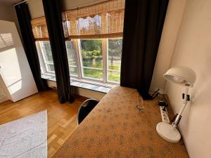 a room with a table with a lamp and a window at Bungalow Östavall Skogsvägen 20 in Haverö