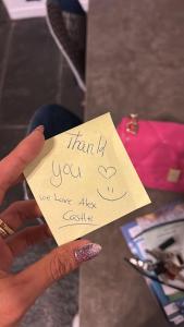 a person holding a piece of paper with a thank you sign at Historic Alex Castle Apartment Lake Como in Gravedona