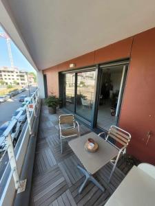 a balcony with a table and chairs on a boat at Gerland T2 standing - balcon - parking privé souterrain in Lyon