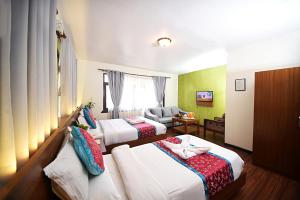 Rúm í herbergi á Hotel Amaryllis Kathmandu