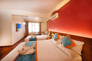 Rúm í herbergi á Hotel Amaryllis Kathmandu