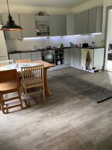 een keuken met een houten tafel en een tafel en stoelen bij Klassisk villa Ljungaverk Borrbodsvägen 1 in Ljungaverk