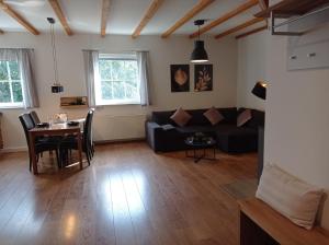 a living room with a couch and a table at kleine AusZeit in Eslohe