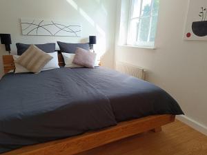 a bedroom with a large bed with blue sheets and pillows at kleine AusZeit in Eslohe