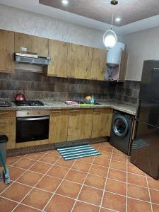 a kitchen with a stove and a dishwasher in it at Luxury resident with pool in Cabo Negro