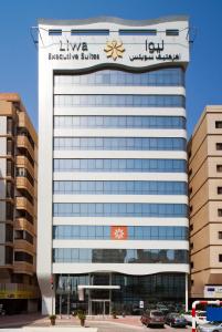 a building with a sign on top of it at Oaks Liwa Executive Suites in Abu Dhabi