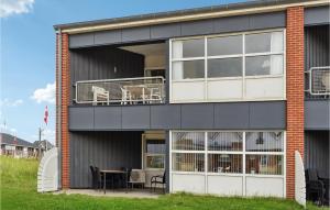 a building with a balcony with a table and chairs at Fan Bad, Lejl, 105 in Fanø