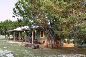 a house with a tree in front of it at #1 Cabaret Bandera Tin Star Bandera, TX in Bandera