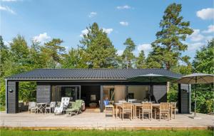 a house with a deck and patio at 3 Bedroom Awesome Home In Silkeborg in Silkeborg
