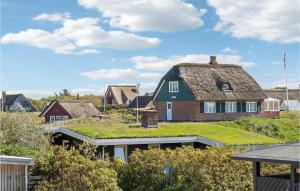 a house with a grassy roof with a house with a house at Fan Bad, Lejl, 67 in Fanø