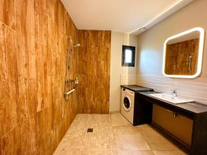 a bathroom with a sink and a washing machine at Gites-domainedupin, cottage "Mosnes à Lisa" in Mosnes