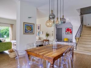 a dining room with a wooden table and chairs at Magnifique Villa MY in Saint-Saturnin