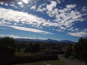 a view of the mountains under a cloudy sky at Pyrenees Vue Gite - Vues Fantastique, Parking Gratuit Sur Place & Piscine in Saint-Gaudens