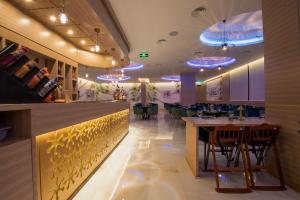 un restaurante con un bar con luces azules en Redwaves Hotel, en Yeda