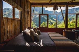 a bedroom with a bed with a view of mountains at GoctaLab in Cocachimba