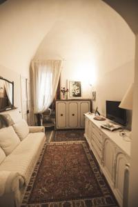 a living room with a white couch and a tv at Leodi in Lecce