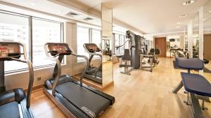 a gym with treadmills and ellipticals in a building at Oaks Liwa Executive Suites in Abu Dhabi