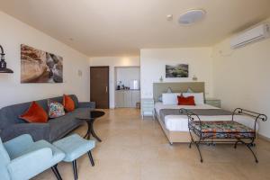 a hotel room with a bed and a couch at Yehelim Boutique Hotel in Arad