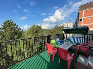 a balcony with colorful chairs and a table and chairs at 38 Apartment 1 in Pristina